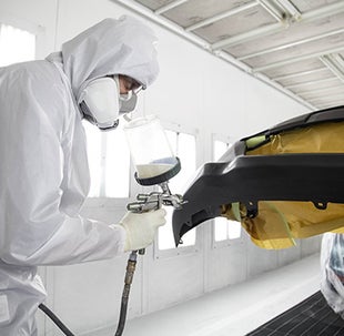 Collision Center Technician Painting a Vehicle | Waldorf Toyota in Waldorf MD